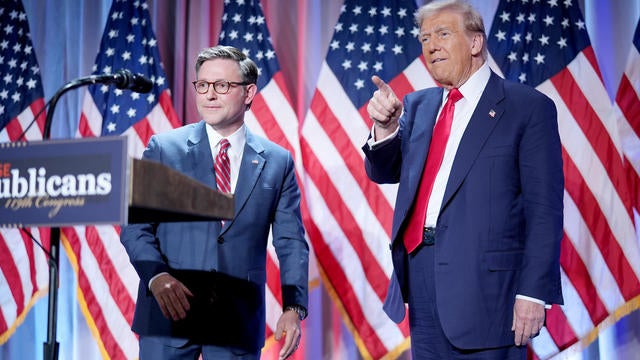 Speaker of the House Mike Johnson welcomes President-elect Donald Trump onstage at a House Republicans Conference meeting at the Hyatt Regency on Capitol Hill on November 13, 2024 in Washington, DC. 