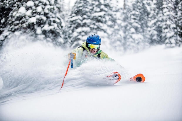 Skier making aggressive turn in deep snow 