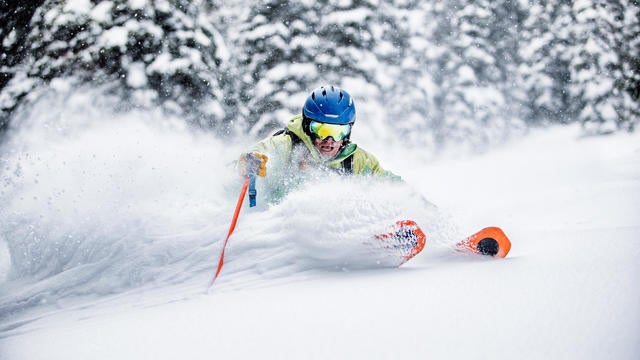 Skier making aggressive turn in deep snow 