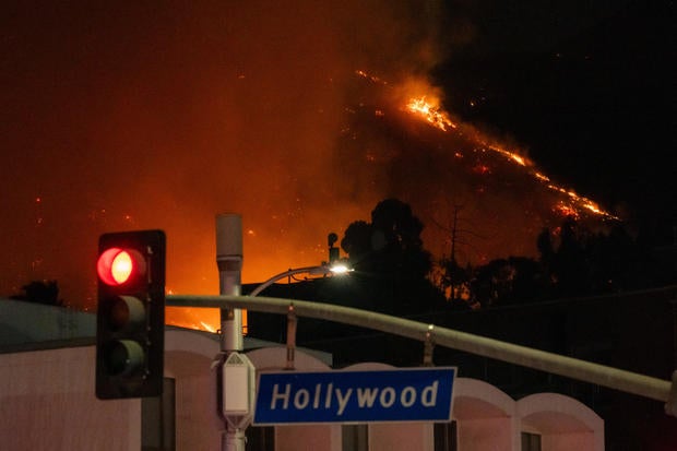 Flames are seen on the hillsides above Hollywood Blvd. during the Sunset Fire 