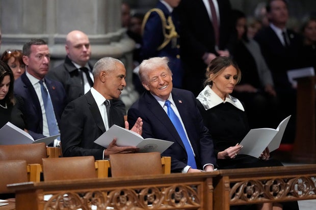 Former President Barack Obama talks with President-elect Donald Trump at former President Jimmy Carter's funeral at Washington National Cathedral on Thursday, Jan. 9, 2025.