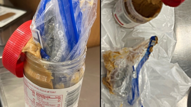 A plastic bag containing marijuana inside an opened peanut butter jar. 