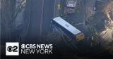 MTA bus hanging over roadway in the Bronx - CBS New York