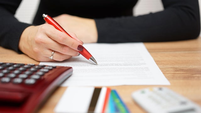 woman is reading bank notice about credit card spending 