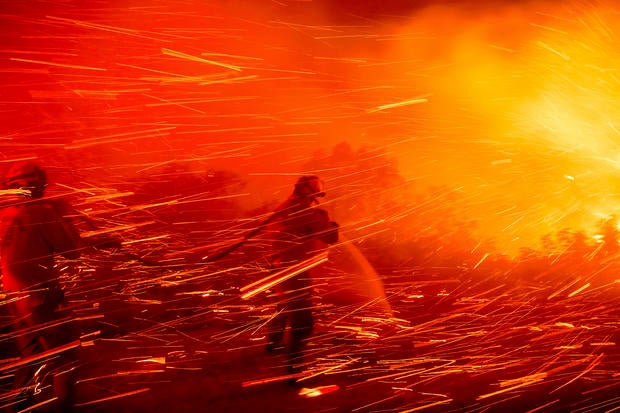 Firefighter Joshua Cari sprays water while battling the Lilac Fire near the Bonsall community of San Diego County, California, Jan. 21, 2025. 