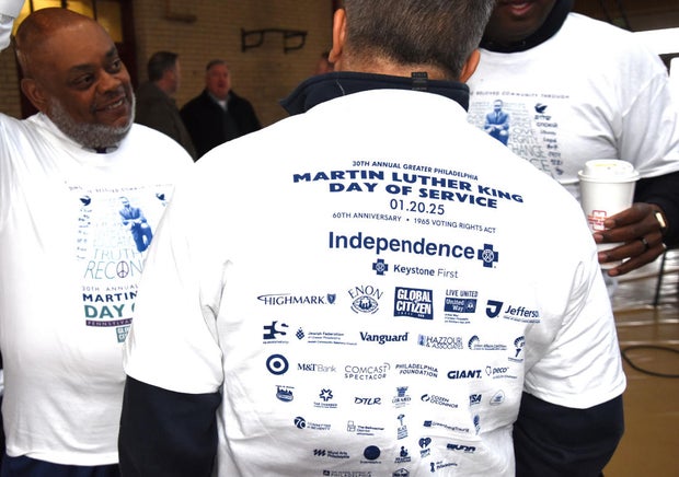 People chat wearing t-shirts that say Martin Luther King Day of Service on the back 