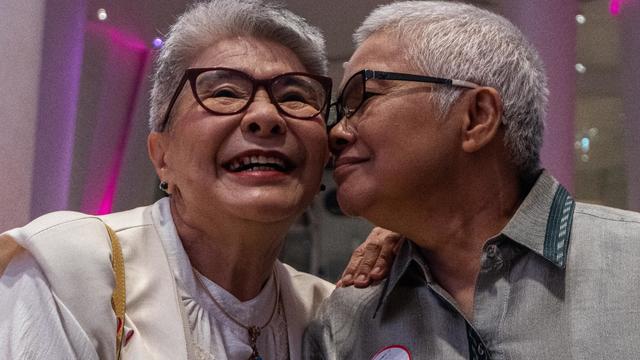 Thai LGBT couple poses for a photo during the registration 