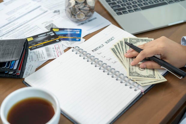 woman calculates monthly expenses at home 