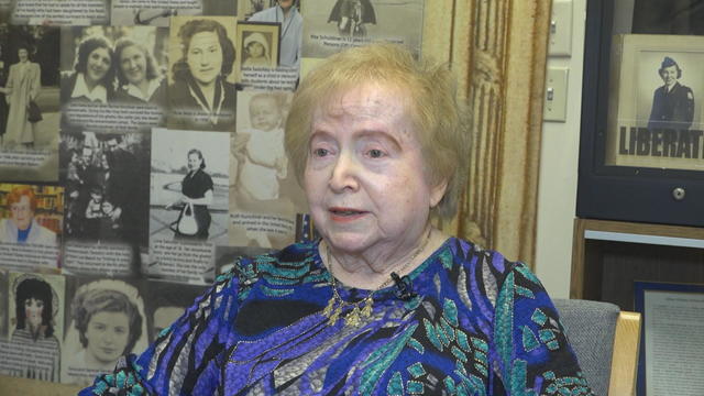 Nella Glick speaks to a reporter at a museum 