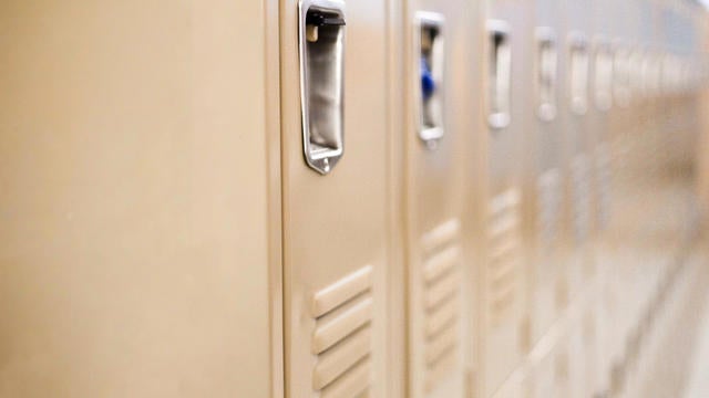 diminishing perspective of row of traditional metal school lockers 