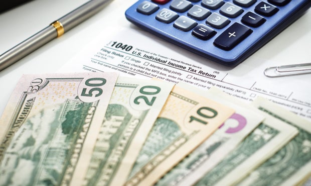 US Currency with calculator and Tax Form