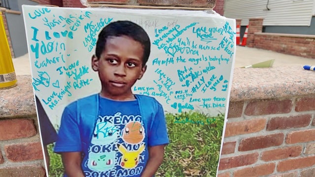 A poster of Yasin Morrison with messages written on it outside a Newark home. 