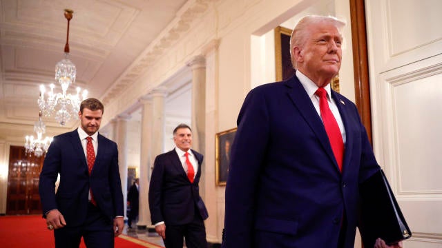 President Trump walks with Florida Panthers captain Aleksander Barkov, left, and team owner Vincent Viola as the president honors the 2024 Stanley Cup champion Florida Panthers in the East Room of the White House on Feb. 3, 2025, in Washington. 