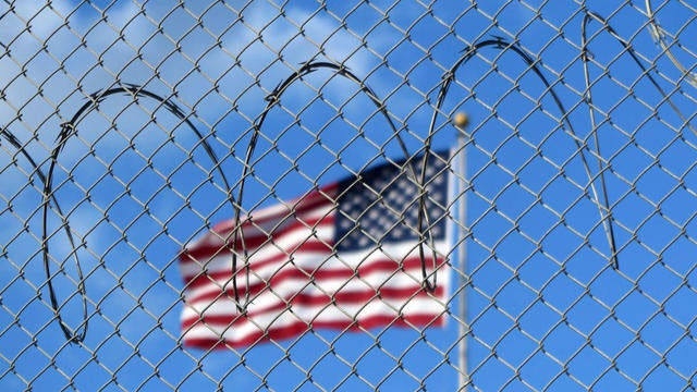 A U.S. flag flies behind barbed wire at the Guantánamo Bay naval base in Cuba on Jan. 15, 2023. 