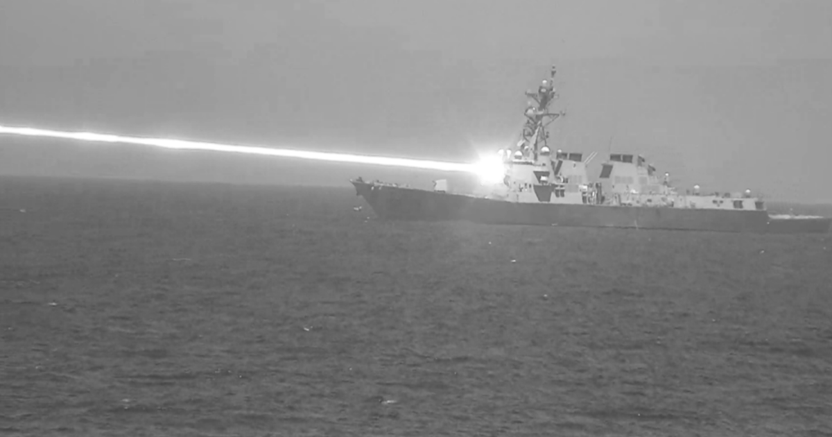 U.S. Navy unveils photo of warship firing high-powered laser weapon