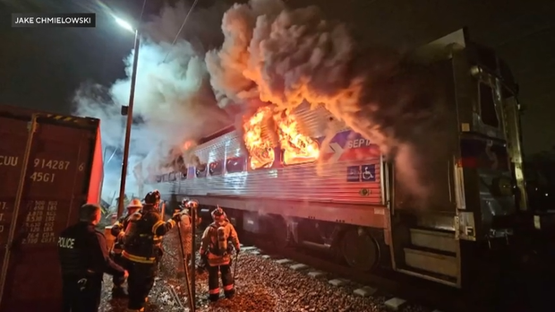 Flames billow out from a SEPTA regional rail car 