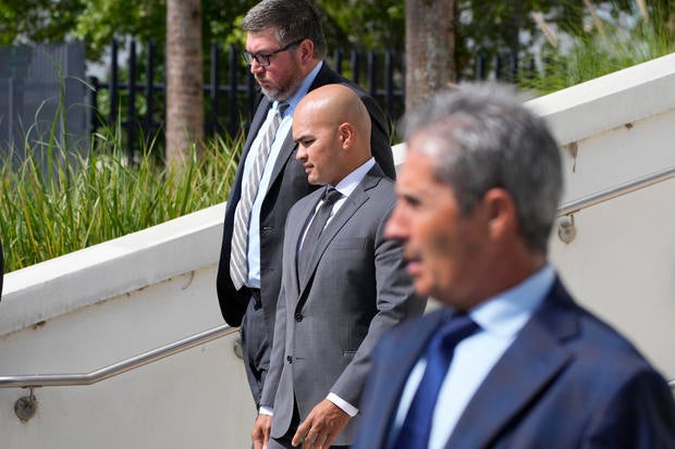 Walt Nauta, middle, leaves the federal Courthouse in Fort Pierce, Florida, on Aug. 10, 2023, with his attorney Stanley Woodward. Mar-a-Lago property manager Carlos De Oliveira is in the foreground. 