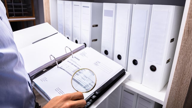 Businessman Examining Bill