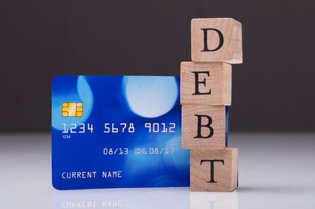 Debt Card And Debt Word On Wooden Block 