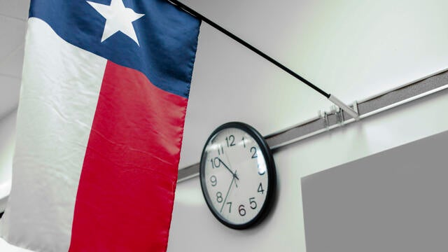 Texas high school classroom flag, clock. 