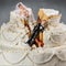 Bride and groom figurines collapsed at ruined wedding cake 