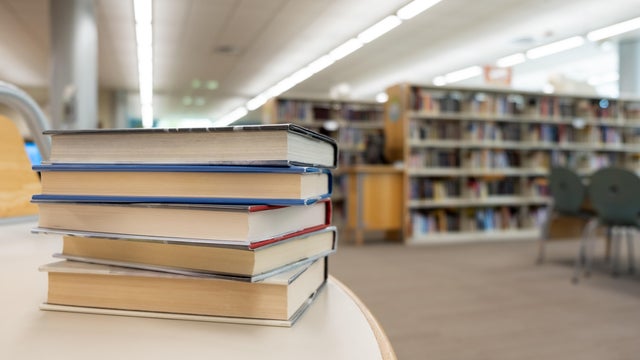 Stack of books on table at library