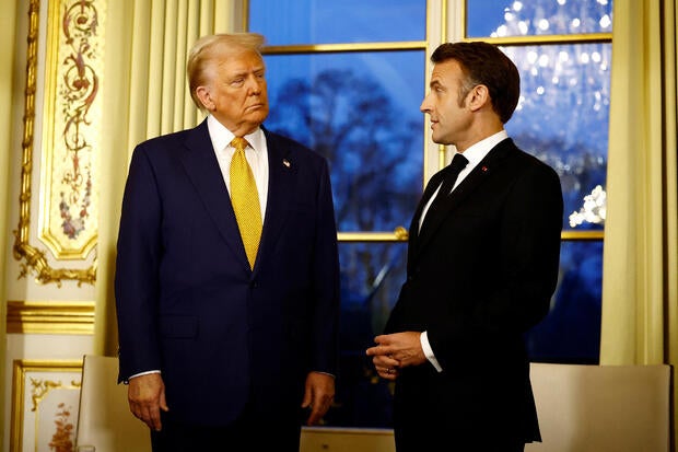 France's President Emmanuel Macron looks at U.S. President Trump during a meeting at the Elysee Palace in Paris, on December 7, 2024.