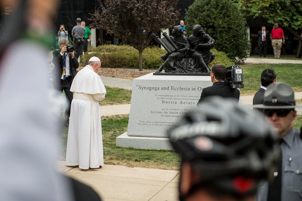 Pope Francis is seen looking at the sculpture on the St. Joe's campus 