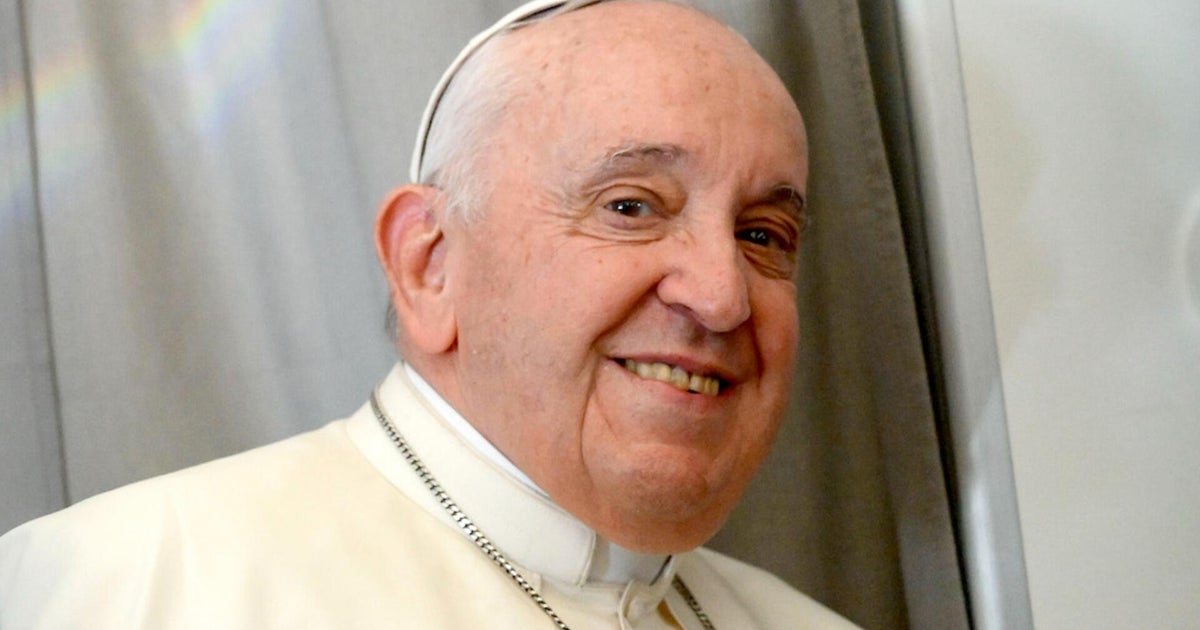 Pope Francis remains hospitalized, shows signs of improvement