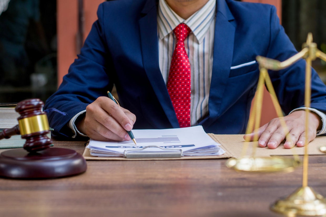 Close up lawyer businessman working or reading lawbook in office workplace for consultant lawyer concept. 