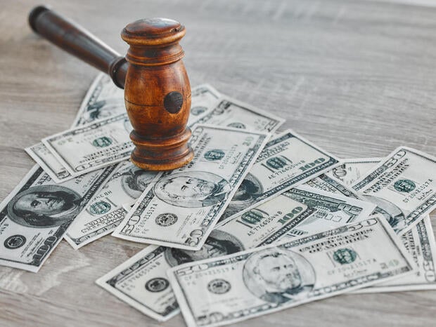 Gavel, money and legal, bribery or fraud with payment deal, criminal or justice in corruption. Background of cash and courtroom hammer for financial crime, auction or debt with ethics or constitution 