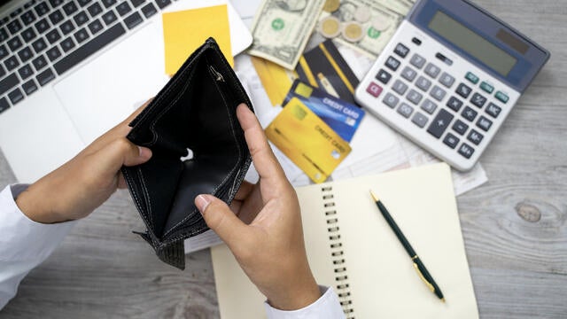 poor Asian woman hand open empty purse looking for money having problem bankrupt broke after credit card payday 