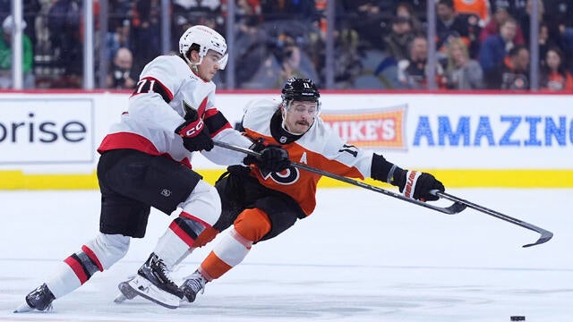 Philadelphia Flyers' Travis Konecny, right, and Ottawa Senators' Ridly Greig battle for the puck during the second period of an NHL hockey game 