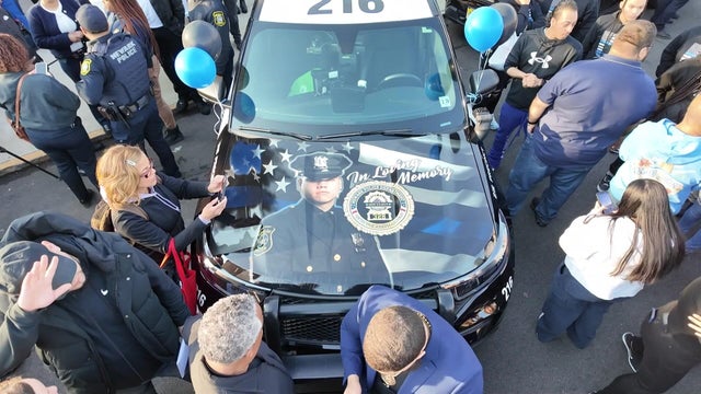 A photo of Det. Joseph Azcona painted on the hood of a Newark Police vehicle. 