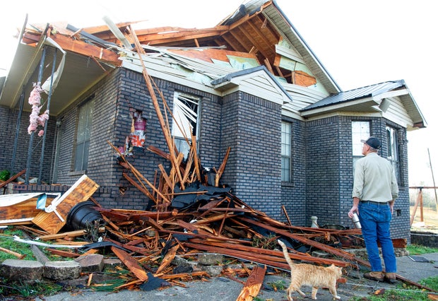 Kerry Walker checks the storm damage of his home after a fatal overnight tornado hit the area in the Alpine community near Plantersville, Alabama, March 16, 2025.