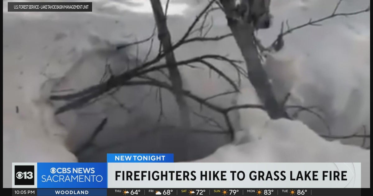 Firefighters hike through snow to battle fire