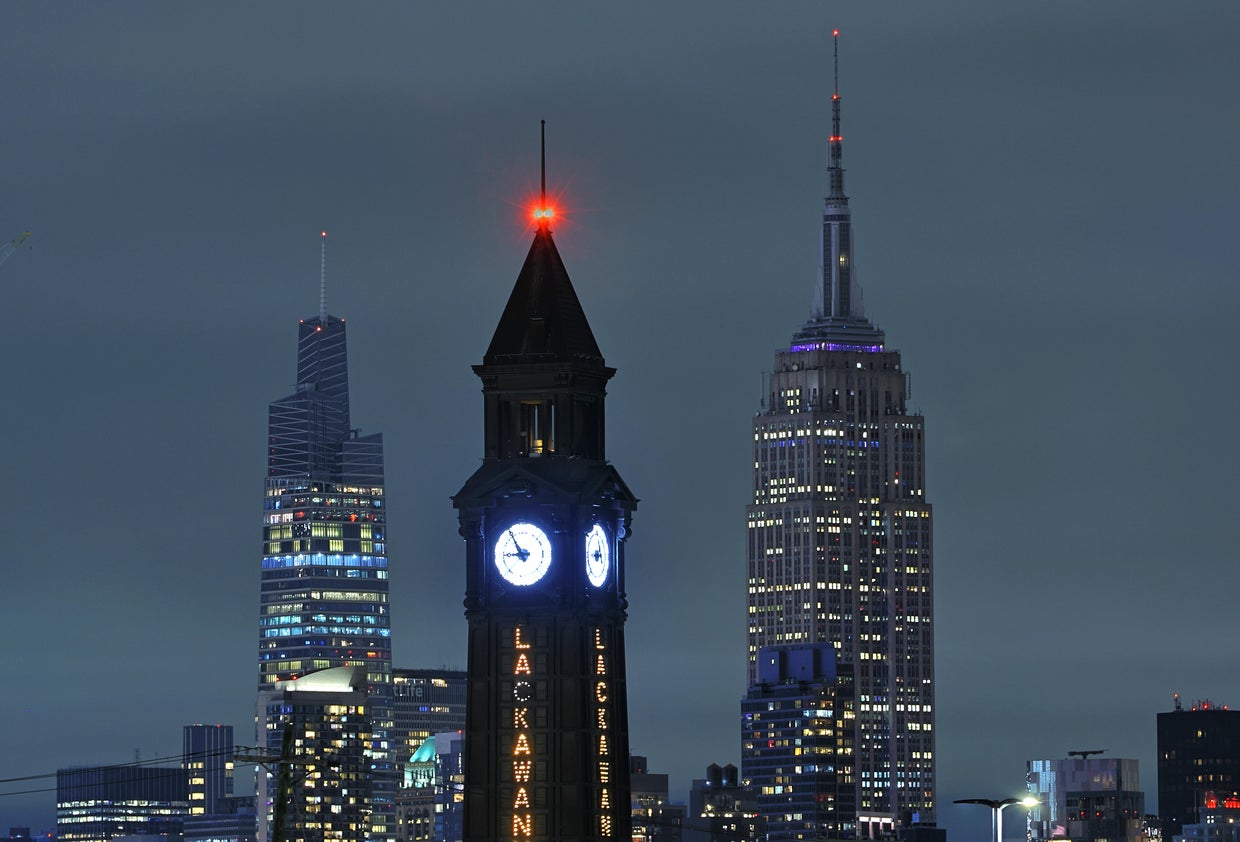 he top of the Empire State Building and One Vanderbilt go dark to mark Earth Hour in New York City as they stand behind the Lackawanna clock tower in Hoboken, New Jersey on March 23, 2024, as seen from Jersey City, New Jersey. 