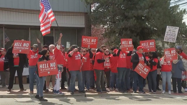 Rally-goers hold signs that say HELL NO outside the Collingswood Post Office in South Jersey 