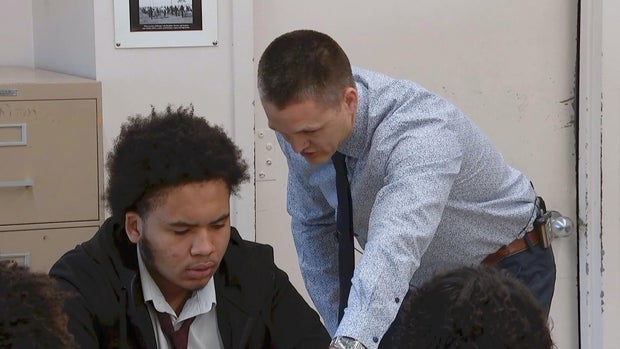 Teacher Steve Novosel works with a student at Northeast High School