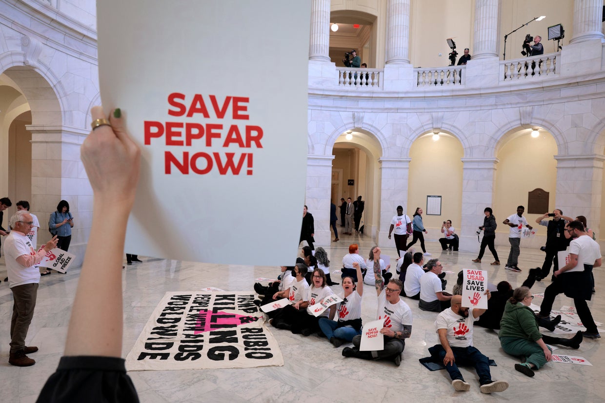 Demonstrators, some of them former PEPFAR and USAID employees, protest to demand that Congress reinstate lifesaving programs in the Cannon House Office Building on Capitol Hill, Feb. 26, 2025, in Washington, D.C. 