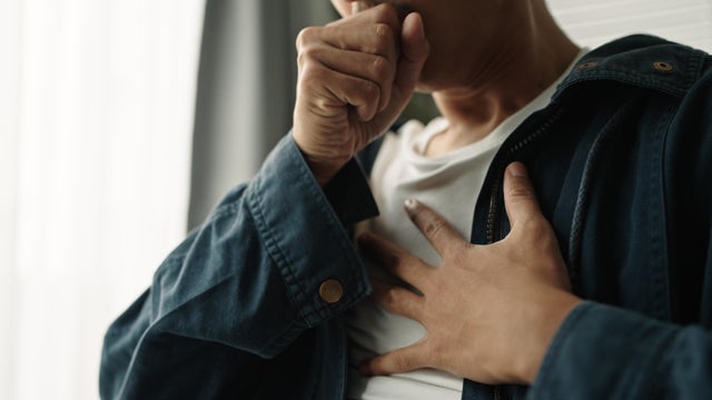 Man touching his chest in pain 