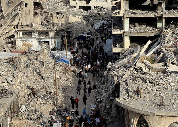 Palestinians shop for Eid al-Fitr amidst rubble in Khan Yunis 
