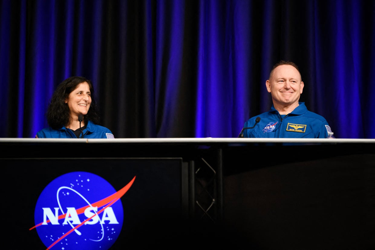 NASA astronauts Suni Williams, left, and Butch Wilmore laugh while answering questions during NASA's SpaceX Crew-9 post-flight news conference at the Johnson Space Center in Houston, Texas, March 31, 2025.