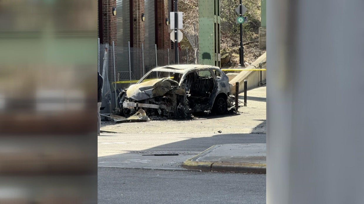 Burned-out car wreckage in Inwood