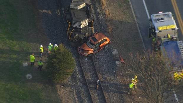 Chopper photo shows A car that is damaged after it was hit by a train, emergency crews are on the scene