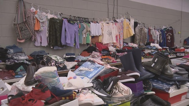 Tables are covered in clothing and shoes donated for the families who were affected by the fire in Millville 