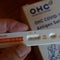 A woman using Covid-19 rapid self-test kit at home 
