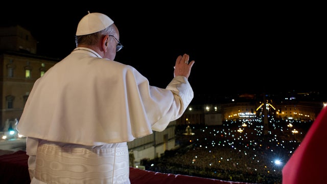Newly elected Pope Francis waves to the crowd at St. Peter's in 2013 