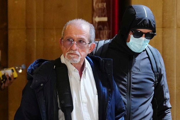 Defendant Aomar Aït Khedache, left, one of the men accused in the 2016 armed robbery of Kim Kardashian, arrives at the palace of justice April 28, 2025, in Paris.