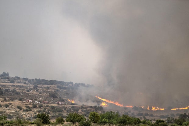 Flames and smoke rise from a wildfire that broke out in a forested area between Tel Aviv and Jerusalem, Israel